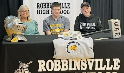 Black Knights senior Skyler Anderson signed a Letter of Intent to wrestle at Ottawa (Kan.) University on May 5. Seated with Anderson are Vickie and Dean Carpenter. Photo courtesy of Robbinsville Wrestling