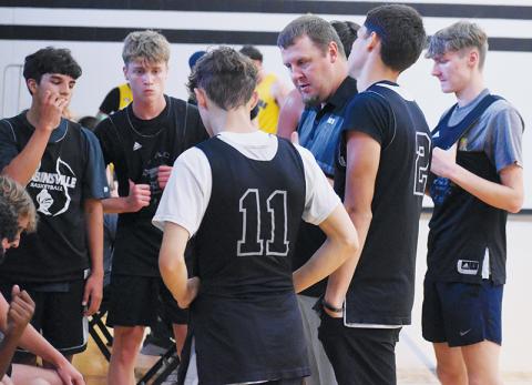 Black Knights head coach Jake Beasley discusses strategy with his players during a timeout at Monday's scrimmage against Murphy. Robbinsville finished its summer with 18 exhibitions under its belt. Photo by Kevin Hensley/sports@grahamstar.com