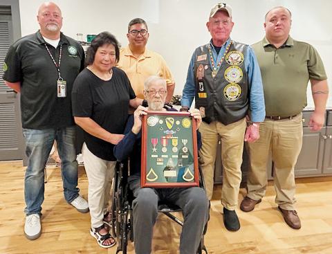 Johnny Harrison Holloway (seated, center) bravely served his country in the Vietnam War. On July 18, medals and honors lost throughout the years were re-issued during a ceremony at New Hope Baptist Church. Standing next to Holloway is his wife Kathy. Across the back are veterans Gerard Ball, Adam Wachacha, Warren Dupree and Josh Holloway.