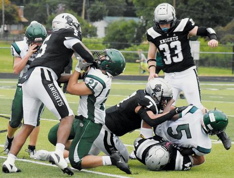 A pair of East Henderson players suffer the consequences of running into  Robbinsville's Kyzik Teesateskie (5), Isiac Collins (7) and Kellen Ensley (54) during Friday's scrimmage with the Eagles. Photo by Lexie Anderson/The Graham Star