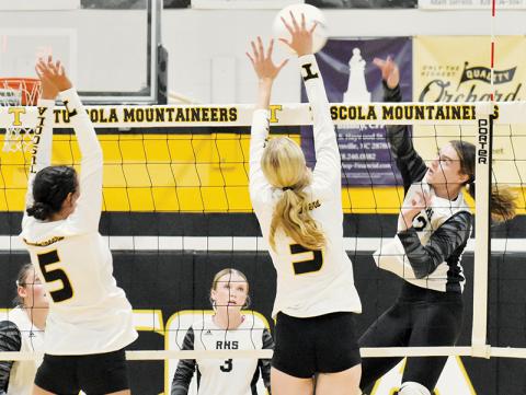 Outside hitter Chloe Adams delivers a spike between the outstretched defense of Tuscola’s Julia Wells (5) and Ivy Jones (3) during Monday’s season opener. Photo by Bella Eddings/The Graham Star