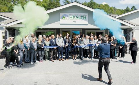 Staff and management of Appalachian Mountain Health celebrate a ribbon cutting held Monday outside the  Robbinsville office on Tallulah Road. The ceremony recognized a recent batch of upgrades to the facility. Photos by Kevin Hensley/editor@grahamstar.com