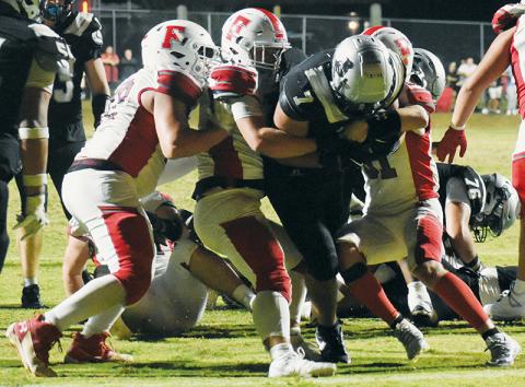 Isiac Collins carries a trio of Franklin defenders en route to Robbinsville’s only touchdown Friday. Photos by Lexie Anderson/The Graham Star