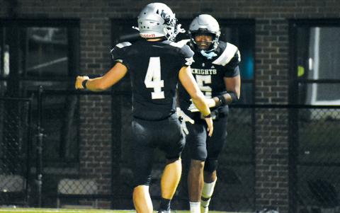 Kyzik Teesateskie (5) flashes a smile at Cameron Allison after scoring his second rushing touchdown Friday night against Mitchell. Photo by Bella Eddings/The Graham Star