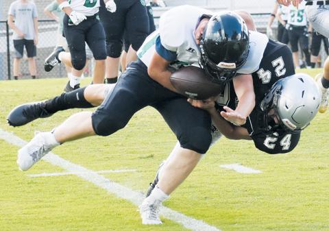 JV Black Knight Mason Silvers tackles a Mountain Heritage ball carrier during Aug. 21's season opener. Robbinsville's defense has held opponents scoreless thus far this season. Photo by Lexie Anderson/The Graham Star