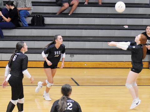 Kynadee Spencer saves the ball from dropping on the outside during Tuesday’s home match against Andrews. Poised to get things back on-track for Robbinsville are Izabel Haney (10), Ryn Hooper (8) and Chloe Adams (12). Photo by Bella Eddings/The Graham Star