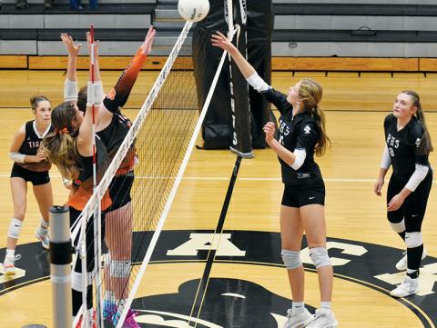Zaelyn Phillips swats the ball over a pair of Rosman defenders during Tuesday's four-set victory over the Lady Tigers. Photo by Bella Eddings/The Graham Star