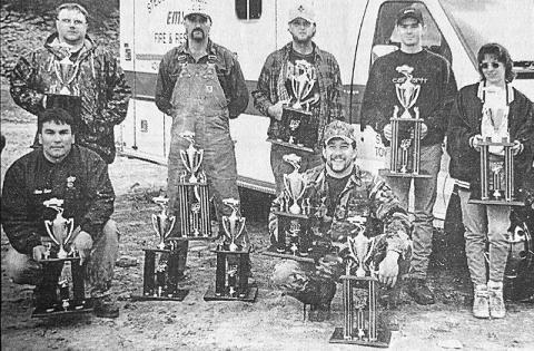 In this photo from the Oct. 23, 1997 edition of The  Graham Star, winners of the Stecoah Rescue Squad's "Mud Sling" show off their trophies. Kneeling in front are Alan Lane (left) and Kelly Burnette. Standing in back (from left) are Todd Dooley, Bobby Smith, John Clark, Dusty Ford and Koby Green. Not pictured are Tommy Sumner and Toby Norman.