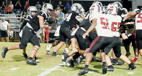 Isiac Collins (7) prepares to enter a scrum during Friday's homecoming game. Collins rushed for 142 yards in Robbinsville's blowout victory over Andrews. Photo by Kevin Hensley/sports@grahamstar.com