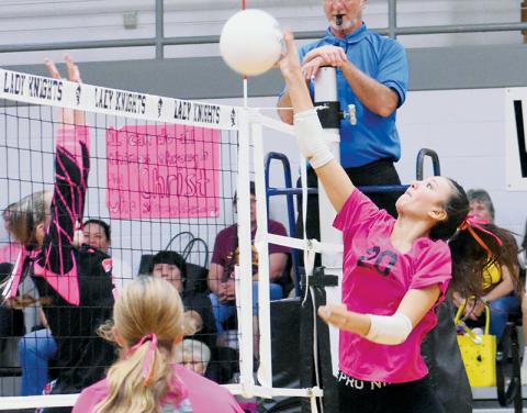 Emory Chekelelee (20) attempts to spike the ball past Cherokee’s Austin Fourkiller-Raby on Monday. Photo by Kevin Hensley/sports@grahamstar.com
