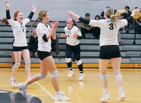 Reality sets in for members of the Robbinsville Lady Knights, moments after completing a sweep of Rosman in the second round of the state playoffs Tuesday. Pictured are Kynadee Spencer (2), Ryn Hooper (8), Zaelyn Phillips and Daphne Barlow (3). Photo by Kevin Hensley/sports@grahamstar.com