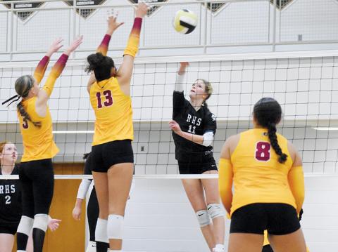 Zaelyn Phillips spikes the ball past the defense of Cherokee’s Austin Fourkiller-Raby (3) and Joscelyn Stamper (13) during Tuesday’s league-tournament semifinal. Photo by Kevin Hensley/sports@grahamstar.com