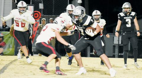 Robbinsville’s Isiac Collins (7) dismisses the defensive effort of Andrews’ Isaac Vaught on a third-quarter rushing attempt during Friday’s second-round playoff game. Photo by Kevin Hensley/sports@grahamstar.com