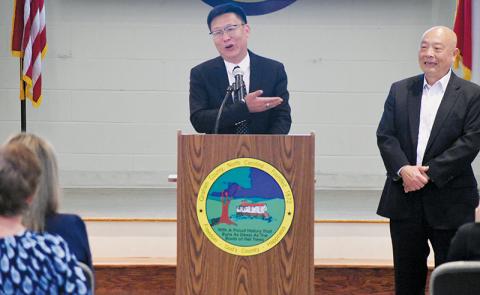 EcoKing Solutions Chairman Ping Zhang heartedly addresses those on-hand for July 22's press conference at the Graham County Community Building, where it was revealed that the China-based manufacturer will create 300 new jobs in the region during its first phase of operations in Robbinsville. At Zhang's left is EcoKing Solutions Vice President John Lin. Photos by Kevin Hensley/editor@grahamstar.com
