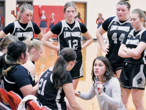 Brooklyn Lester speaks to the Lady Knights during a timeout at Copper Basin on Dec. 1. Robbinsville’s new varsity girls head coach has dove into the role with  purpose, hoping to restore the program as a centerpiece in the community. Photo by Kevin Hensley/sports@grahamstar.com