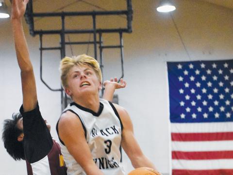 Middle school Black Knight Brayden Allison soars past a Cherokee defender Nov. 17. Allison hit a game-winning lay-up for Robbinsville on Monday at Hayesville. Photo by Kevin Hensley/sports@grahamstar.com