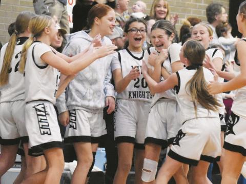 Teammates mob Robbinsville Middle School's Mercy Nelms (center) on Dec. 4, moments after Nelms hit a three-pointer at the final buzzer to cement a 42-34 home victory over Swain County. Photo by Kevin Hensley/sports@grahamstar.com