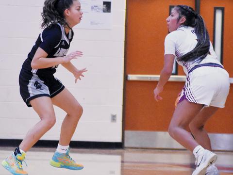 Robbinsville's Aaliyah Wolfe (left) keeps a watchful eye on Cherokee's Dvdaya Swimmer during Friday's conference road game. Photo by Kevin Hensley/sports@grahamstar.com