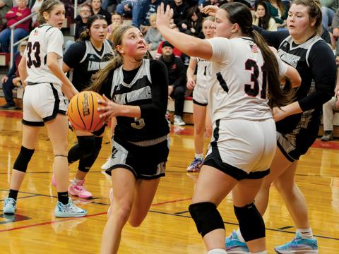 Lady Knights senior Abby Wehr looks to evade the interior defense of Andrews' Alexis Beasley during Friday's clash. The following evening at Smoky Mountain, Wehr delivered a 30-point performance for Robbinsville in a victory over the Mustangs. Photo by Cannon Crompton/Cherokee Scout