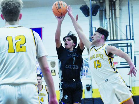 Xamuel Wachacha (1) attempts to evade the defense of Murphy's Abram Twiggs and shoot a 3-pointer during Feb. 12's Smoky Mountain Conference title game. Photos by Bella Eddings/The Graham Star