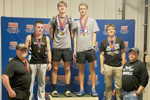 The Robbinsville Black Knights capped a strong showing at Feb. 11's state indoor track meet by winning their third championship of the day in the 4x400 relay. From left are head coach Dale Farr, Austin Bohn, Nathan Frederick, Benjamin Frederick, Colton McCoy and assistant coach Jeremy Lunsford. Photos courtesy of Robbinsville Indoor Track and Field