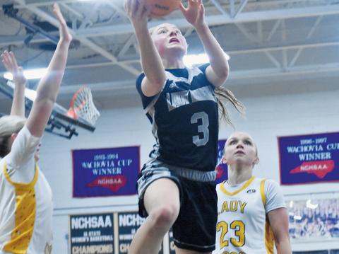 Robbinsville senior Abby Wehr splits the defense of Murphy's Kennedy White (3) and Emma Hensley (23) for a second-half lay-up attempt Feb. 12. Photos by Bella Eddings/The Graham Star