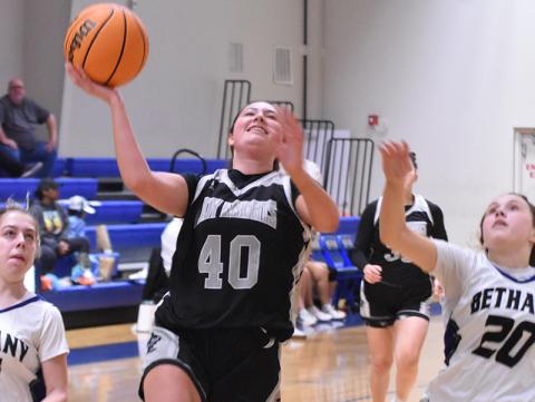 Lady Knights sophomore Bella Coats (40) breaks away from Bethany Community School's Brooke Carter (11) and Ryleigh Wiseburn (20) in the fourth quarter of Thursday's second-round playoff game. More photos can be purchased at geosnapshot.com/grahamstarsports. Photo by Kevin Hensley/sports@grahamstar.com