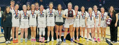 The Robbinsville Lady Knights gather with the 1A state championship runner-up plaque at half-court March 11, after dropping the title game 58-44 to Wilson Preparatory Academy. Photos by Kevin Hensley/sports@grahamstar.com