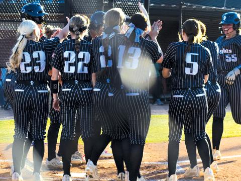 With the rest of the Lady Knights waiting to greet her, Dreylee Webster (55) trots into home plate after hitting her first of two home runs April 9 against A.C. Reynolds. Photo by Bella Eddings/The Graham Star