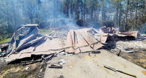 This vacant home at 3744 Santeetlah Road burned Friday, igniting nearby woods and burning two acres of tribal land. Photo courtesy of Tory Lynnes/U.S. Forest Service