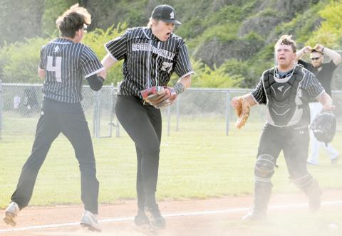Robbinsville's Peyton Brooks (27) celebrates with teammates Everett Taylor (4) and Rylen Orr after tagging out Murphy's Aayden Williams at the plate April 30, securing the Black Knights' first victory over the Bulldogs since 2019. Photo by Kevin Hensley/editor@grahamstar.com