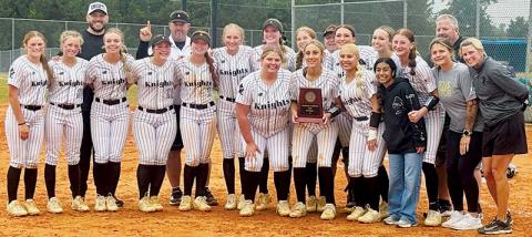 The Robbinsville Lady Knights gather around the 2026 1A Western Regional championship plaque, minutes after clinching the program's first-ever state-title appearance. Photo courtesy of Sasha Watty/Contributing Photographer