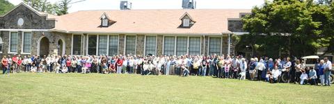 Attendees at Saturday's Stecoah 100th Anniversary Celebration gather to re-create the Dedication Day photo that was captured when the former school opened a century ago. Photos by Kevin Hensley/editor@grahamstar.com