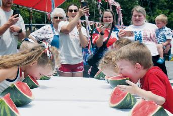 Parents and family members alike cheer on the 0-5 age group during Satuday's watermelon-eating contest, which was held as part of the Graham County Heritage Festival. Photo by Bella Eddings/The Graham Star