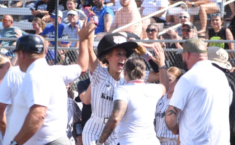 Adorned with the Lady Knights' "Home Run Hat," Robbinsville senior Anna Williams celebrates after hitting a grand slam in the first inning of Friday's state-championship series opener. Williams finished the game with six RBIs. Photo by Kevin Hensley/editor@grahamstar.com