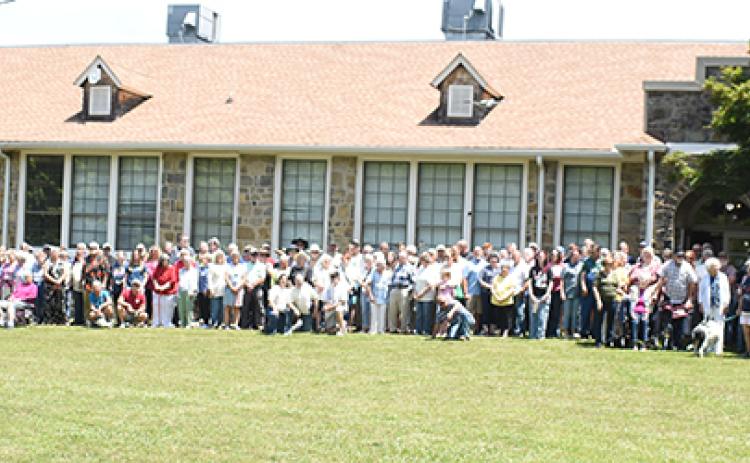 Attendees at Saturday's Stecoah 100th Anniversary Celebration gather to re-create the Dedication Day photo that was captured when the former school opened a century ago. Photos by Kevin Hensley/editor@grahamstar.com