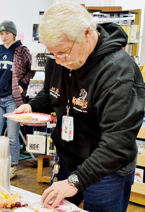 Graham Star photographer Art Miller grabs a snack at a Jan. 17, 2020 assignment. Miller is retiring from his role with the Star after 14 years of service. 