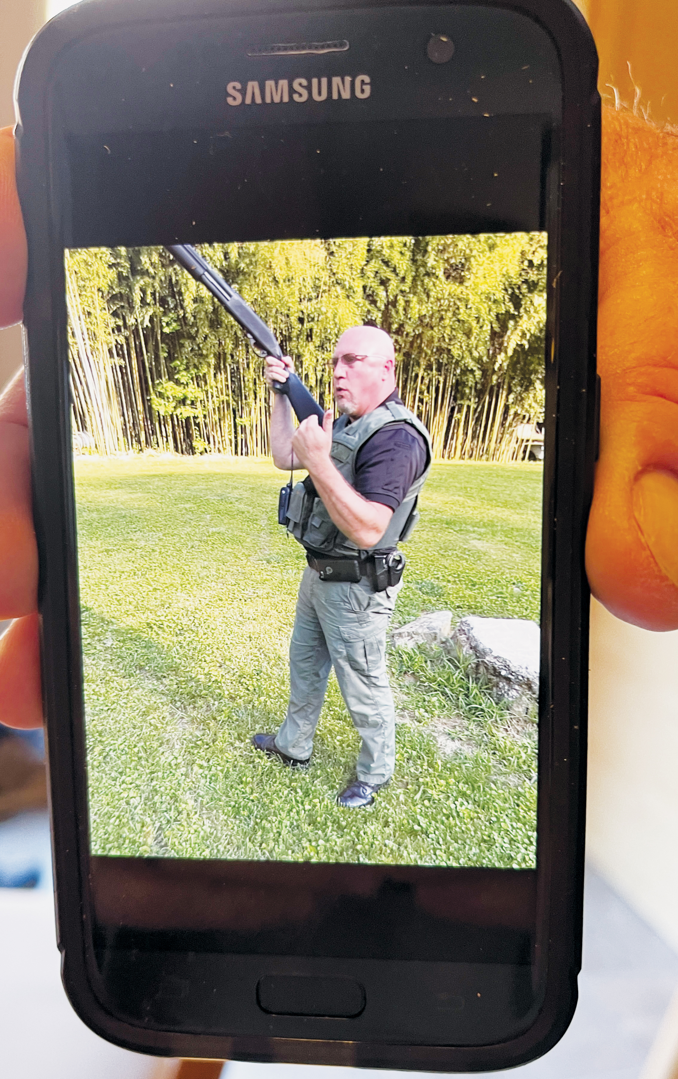 Gerry Laschober shows a photo taken on his cell phone in June 2017, when the search for a missing hunting dog ended with officers on his property at Cooper Creek Trout Farm in Ela. After asking the officers to leave, then-Swain County Sheriff’s Office Lt. Charles Robinson allegedly wielded this shotgun and told Laschober he was going to “cut him in half.”