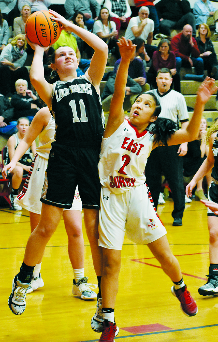 Robbinsville's Karlyn Matheson (11) delivers a jumper over the outstretched hands of East Surry's Rosie Craven during Feb. 27's second-round playoff game in Pilot Mountain. Photos by Kevin Hensley/editor@grahamstar.com