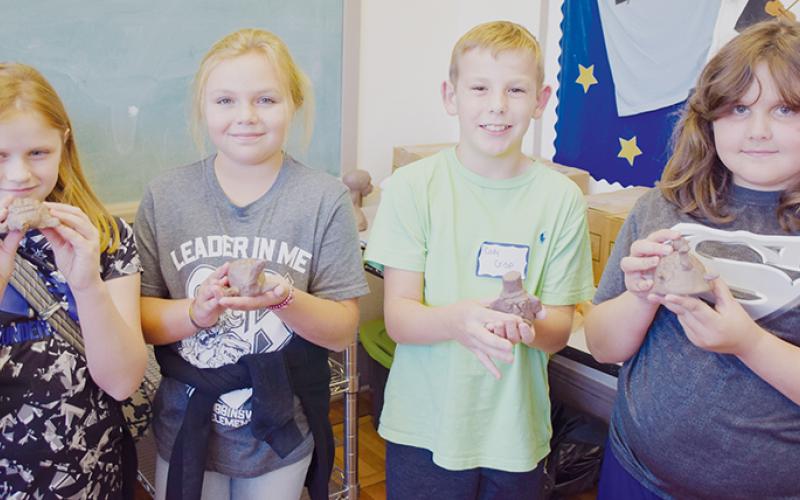 Katie McCracian, Sydney Adams, Cody Crisp and Ella Atwell (from left) show off the clay artwork they created at last week’s Arrowmont Program, held at the Stecoah Valley Cultural Arts Center. Photo by Art Miller/amiller@grahamstar.com