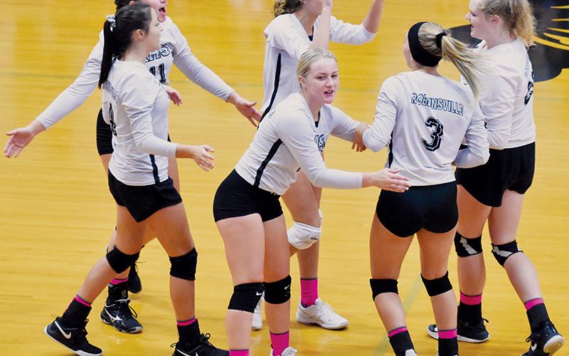 Lady Knights Kennedy Cable, Karlyn Matheson, Liz Ayers, Yeika Jimenez, Gracye Burchfield and Karcee Dooley (from left) celebrate after a point during Oct. 10’s sweep against Rosman. Photo by Kevin Hensley/editor@grahamstar.com