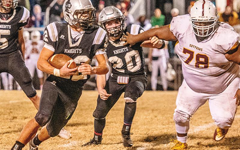 As Lex Hooper (20) attempts to slow down Thomas Jefferson’s Isaiah Foster – listed at 5-foot-10 and 390 pounds – Robbinsville’s Rylee Anderson finds some open real estate during Friday’s 1A Western Regional Championship game. Anderson scored a trio of fourth-quarter touchdowns in the Black Knights’ 28-14 victory.