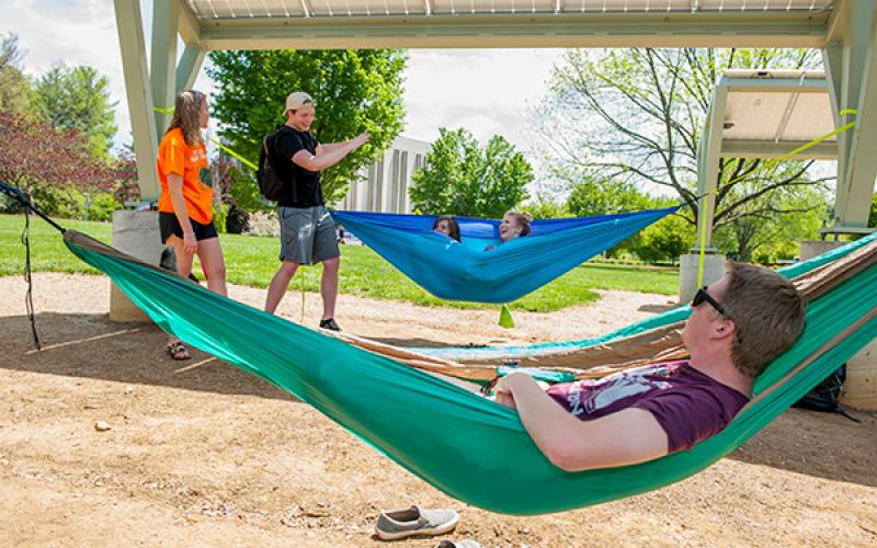 Students enjoy a sunny day at WCU’s Electron Garden on the Green, a power-producing 10-kilowatt solar photovoltaic system and hammock hanging lounge.