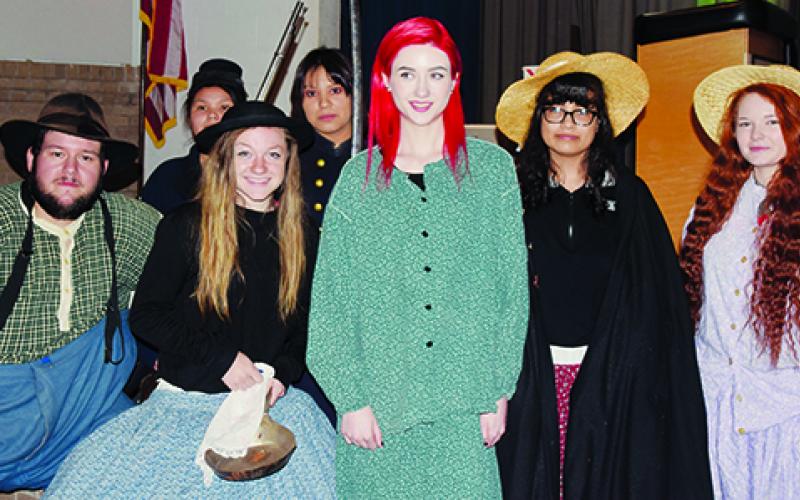 Re-enactor Austin Walls (far left) joins Robbinsville High School students Bethany Collins, Kaylee Phillips, Trinity Bailey, Virginia Stroud (front, from left); Kitty Driver and Rebecca Ballou (back, from left) in getting into the spirit of the Civil War unit taught at the school Monday.