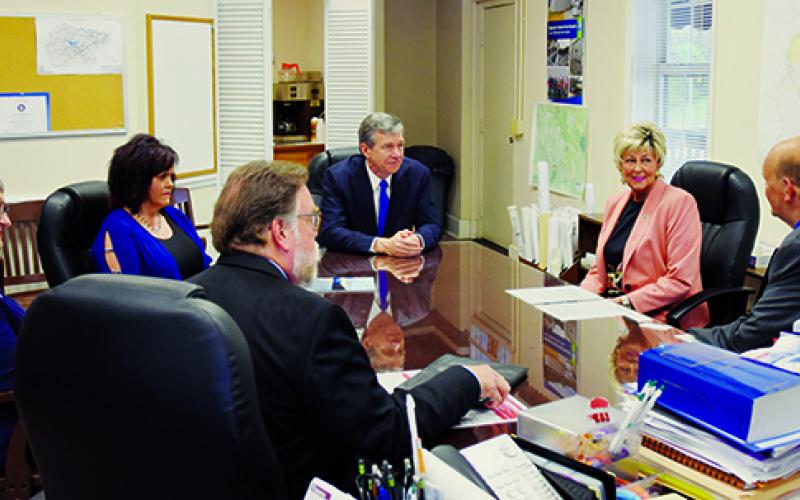 North Carolina Governor Roy Cooper and an aide get acquainted with (from left) ARC Community Development Planner Ann Bass, Clerk of Court Tammy Holloway, Commissioner Connie Orr and Robbinsville Mayor Steve Hooper during his visit to Graham County on April 12. Photo by Art Miller/amiller@grahamstar.com