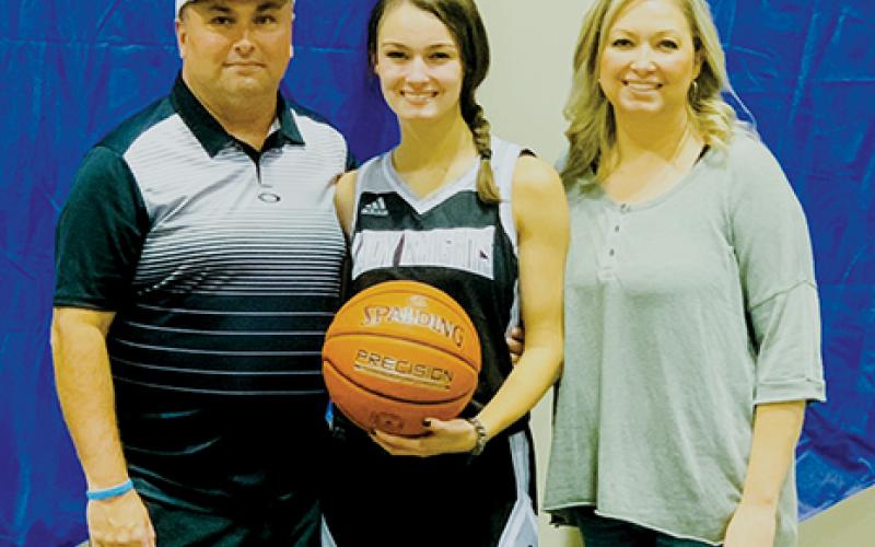 Robbinsville senior Cambrie Lovin scored her 1,000th career point during the KSA tournament in Orlando on Saturday. Lovin is pictured with parents Brandon and Haley, moments after achieving the accomplishment.