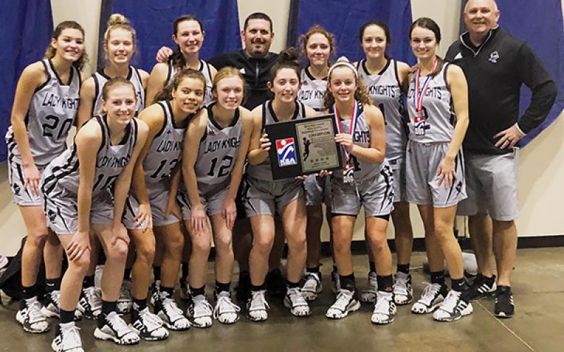 The Robbinsville Lady Knights clinched the 2019 KSA Christmas Tournament championship Monday in Orlando. Front row (from left) are Kandace Holder, Lina Pagan, Ava Barlow, Gabby Hooper and Desta Trammell. Back row (from left) are Yeika Jimenez, Kensley Phillips, Karlyn Matheson, head coach Lucas Ford, Halee Anderson, Kennedy Cable, Cambrie Lovin and assistant coach Mitch Beasley. Photos by Brandon Lovin/Contributing Photographer