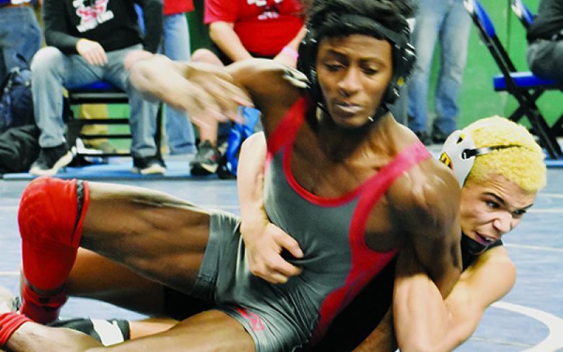 Jayden Nowell brings down South Stanly’s Jaquavius Caraway during the first round of the 126-pound bracket competition Friday.