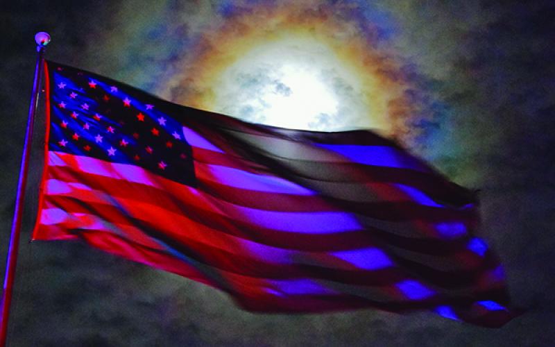 Timing is everything, as the sun illuminated this U.S. flag at Fontana Dam to create a true “Awe-Inspiring Sight.” Photo by Art Miller/amiller@grahamstar.com