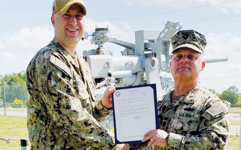 Navy veteran and Graham County resident Jason Marino (right) was recently  promoted to Master Chief. Presenting Marino with his Frocking Letter is Commander Henderson.